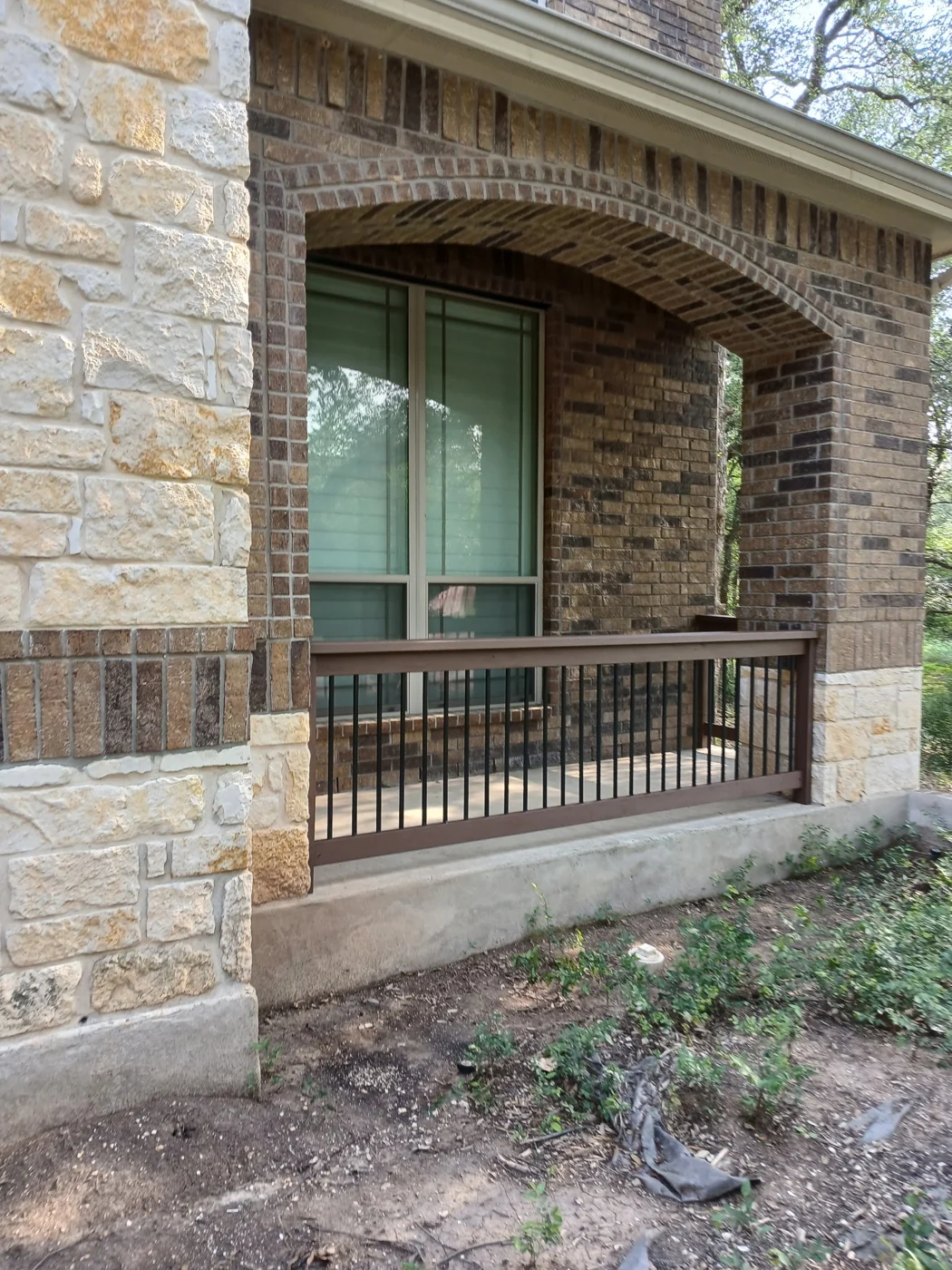 A view along the wooden deck railing beside the house.