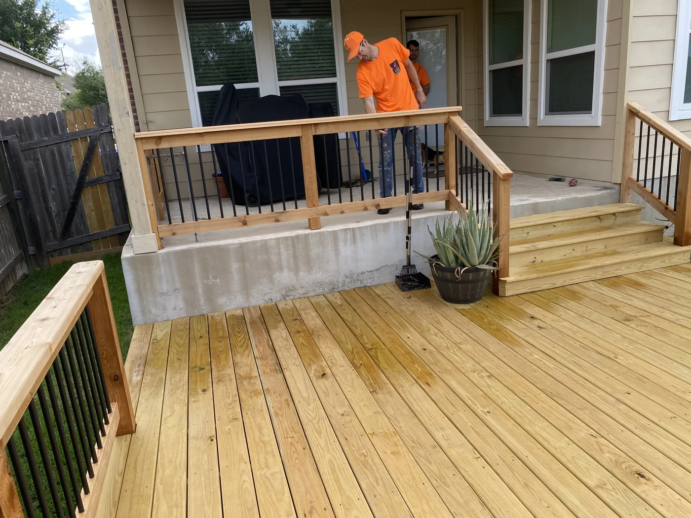 A view of deck boards, railings and the entrance to the home.