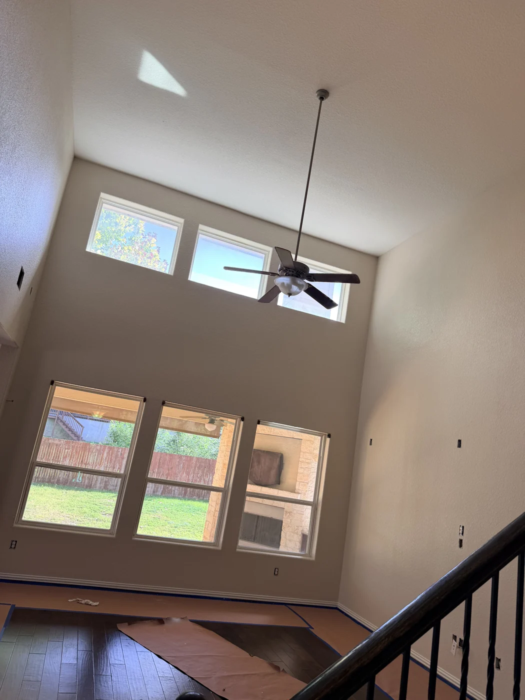 A view of the walls, upper windows and stairwell before the work is complete.
