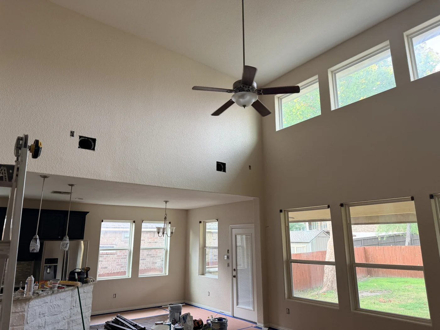 High walls, windows and connected spaces all become part of the painting plan.