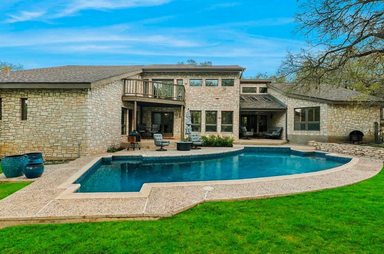 Poolside exterior before painting, with natural stone and tan finishes