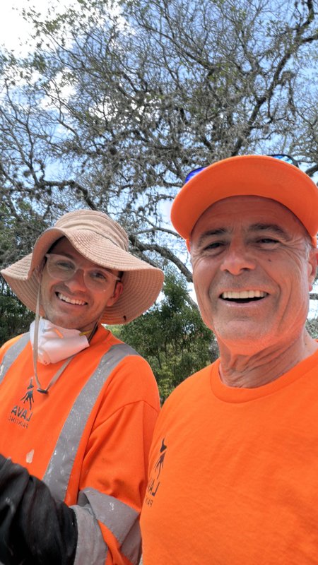 Lava Painting team members in orange work shirts on an exterior project